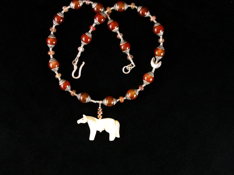 Small ox bone horse on necklace of Tibetan carnelian beads