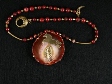 Brass "flying" horse going over brass tree on red flake jasper druzy