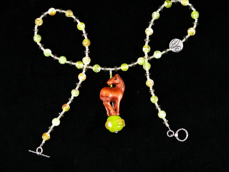 Chinese boxwood horse standing on yellow glass "sun"