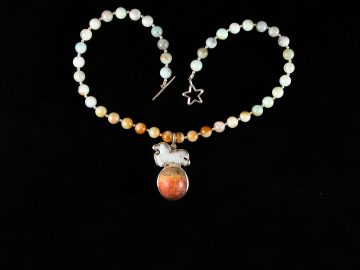 Jade horse jumping a red jasper moon