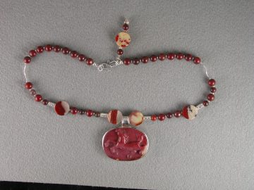 Red flake jasper horse pendant set in sterling on necklace of red flake jasper beads