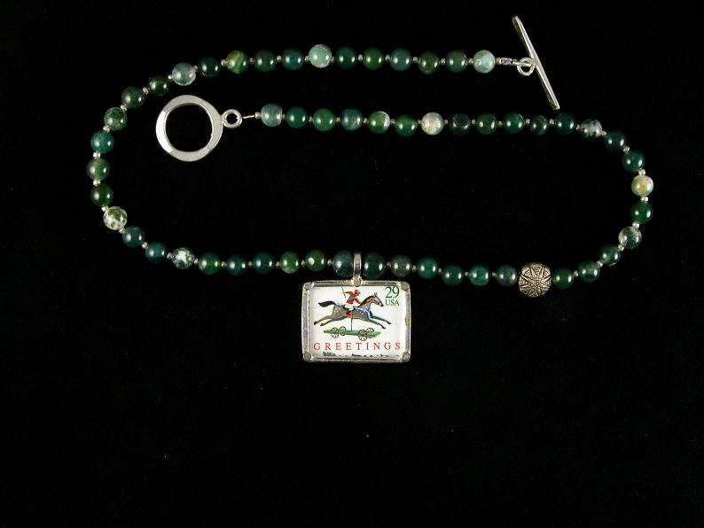 Pendant with USPS stamp with horse and rider