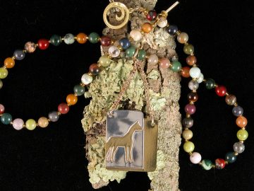Sterling cut out standing horse on brass on necklace of mixed gems