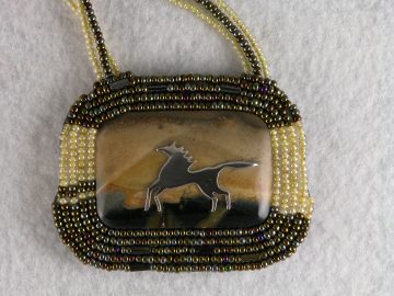 Sterling horse on landscape jasper framed with yellow and green tone seed beads