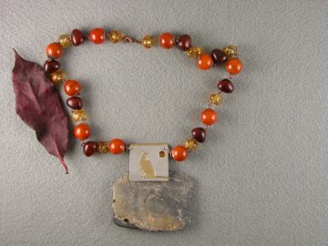 Sterling cut out cat on brass pendant with faceted sun accent bead