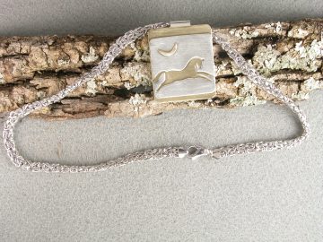 Sterling cut out leaping horse on brass with brass quarter moon