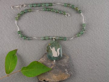 Sterling cat reaching toward a Swarovski crystal sun