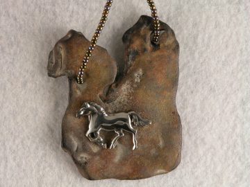 Sterling cantering horse on piece of archaic pottery from Botany Island, SC