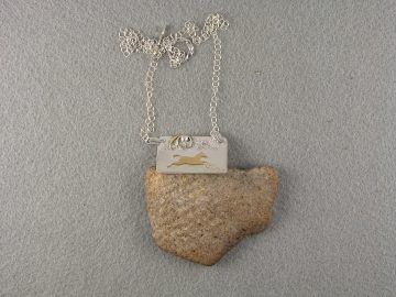 Brass horse leaping across "hills" on sterling pendant with sky accents
