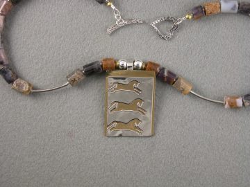 Leaping horses on brass